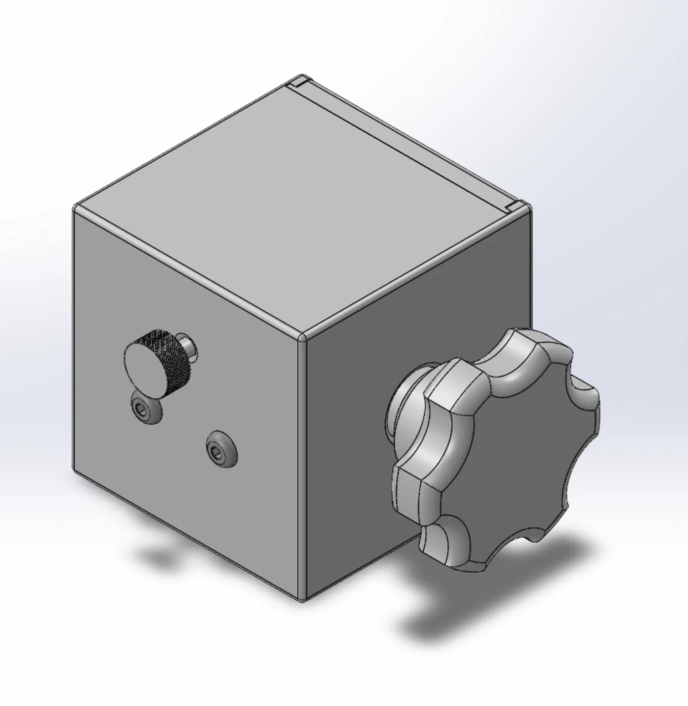 SolidWorks render of Version 2 assembled: a grey 105 mm cube with a seven-lobed star knob on one face and a knurled adjustment screw plus two lid screws on the adjacent face.