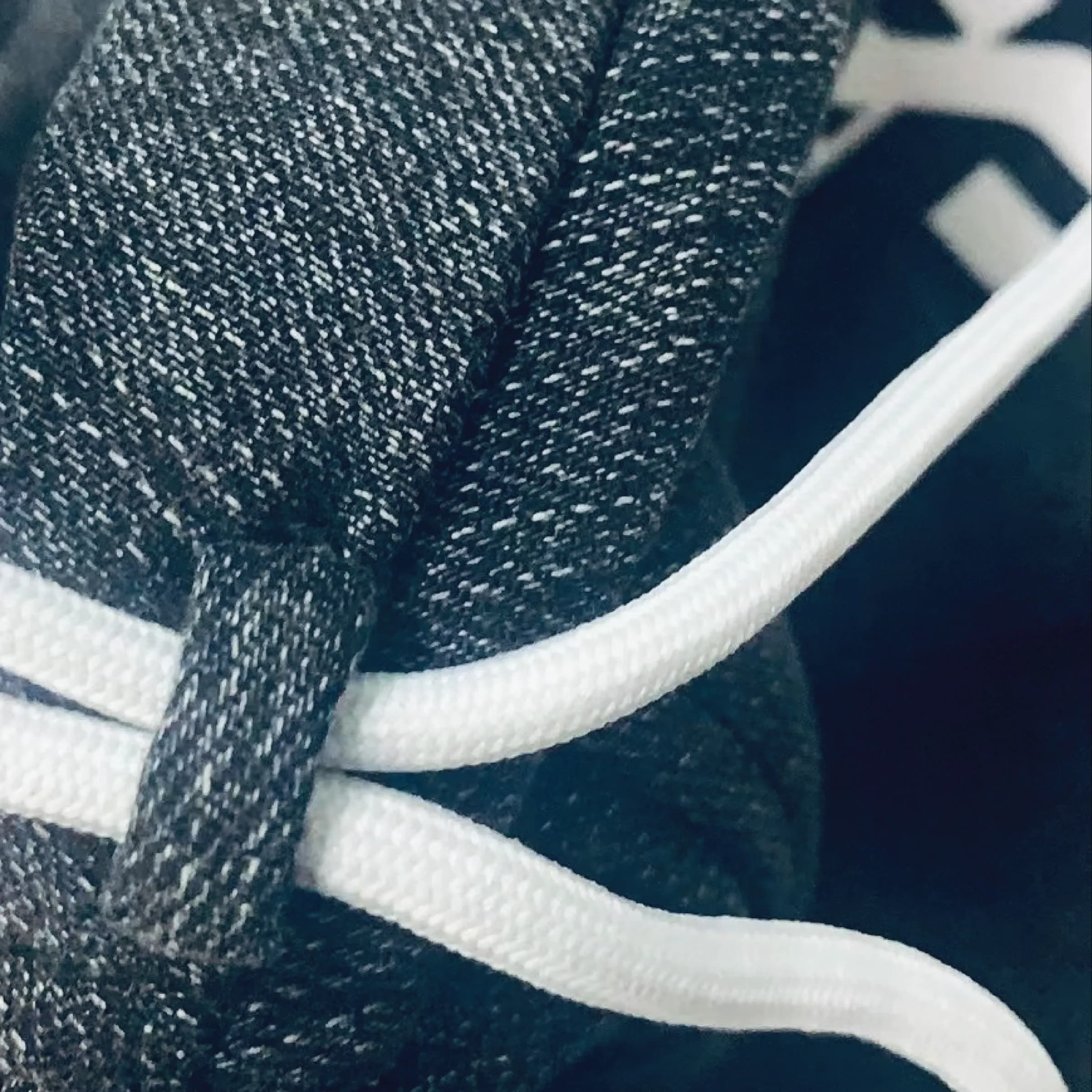 Macro photo of the volcanic rock velvet denim with a thick white drawstring cord