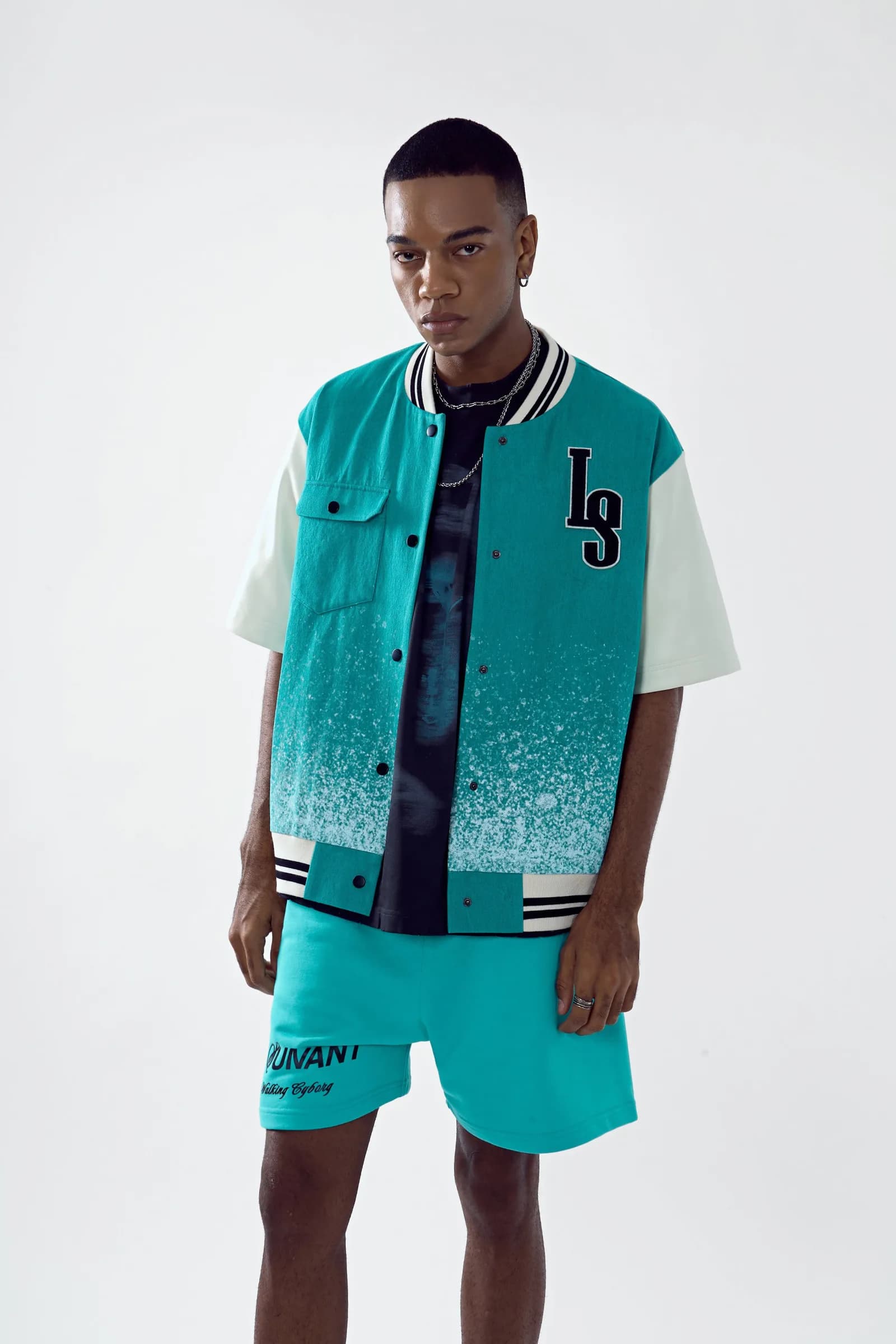 Model wearing the Chip Body bomber open over the Birth tee with cyan shorts