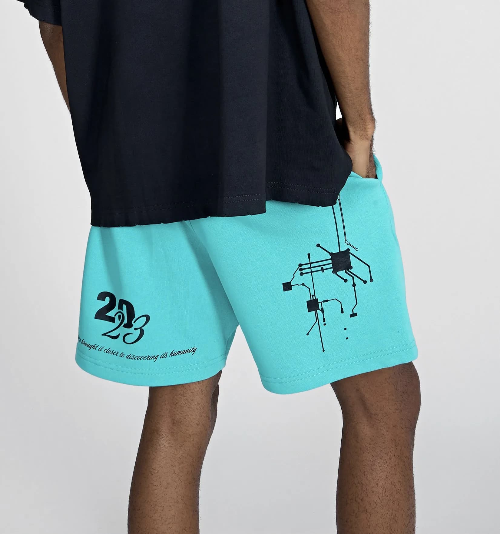 Close-up of the cyan Cyborg Classic shorts back leg with the 2023 script and motherboard print